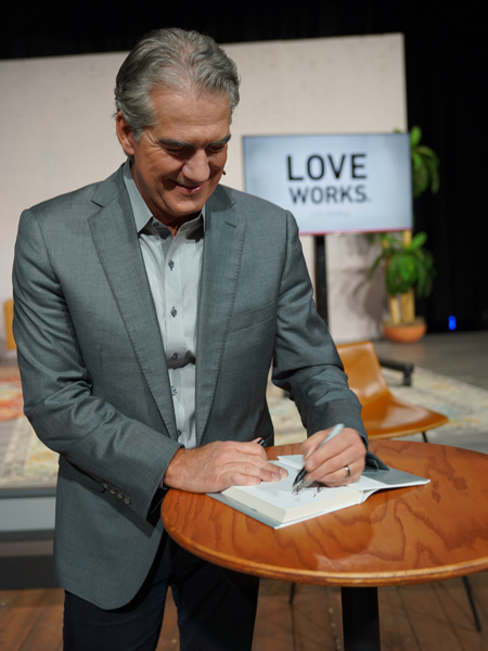 Joel Manby signing a book