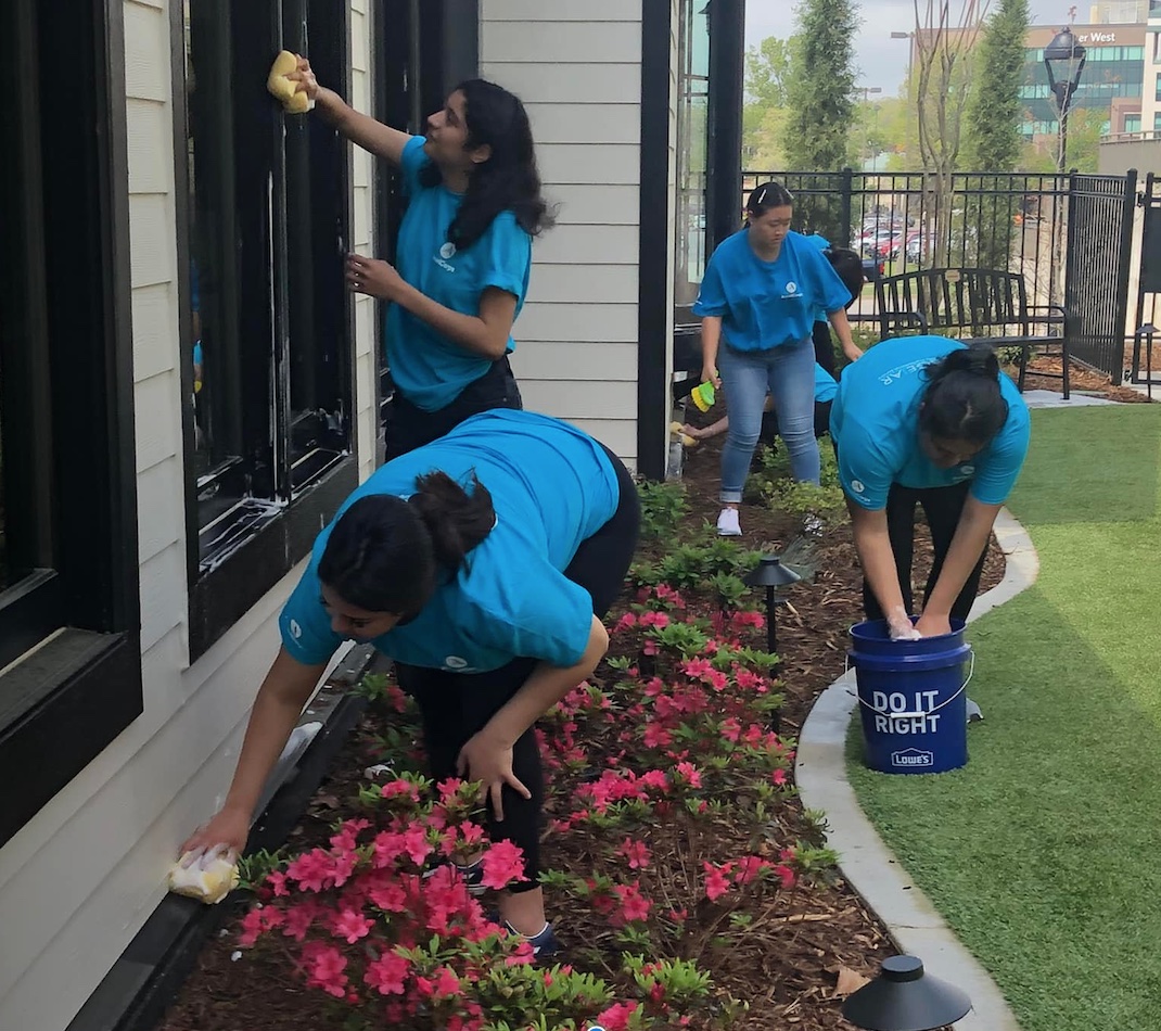 University students cleaning a building