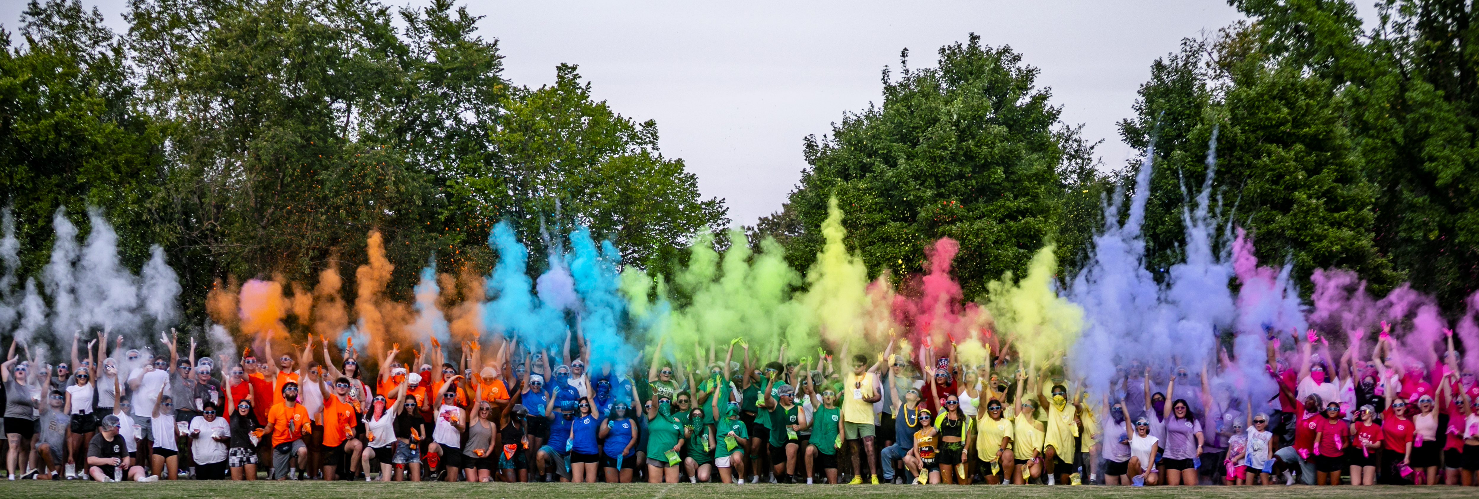 cubcamp participants throw colored powder into the air before starting the fall 2025 semester