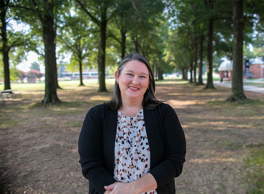 Dr. Camille Wheeler smiles underneath the trees in the UAFS Campus Green