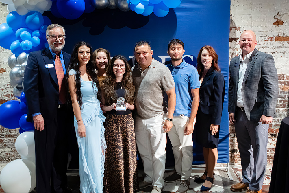 Elmer Reyes, of Elmer's Chem-Dry, accepts his award for Hispanic-Owned Small Business with his family