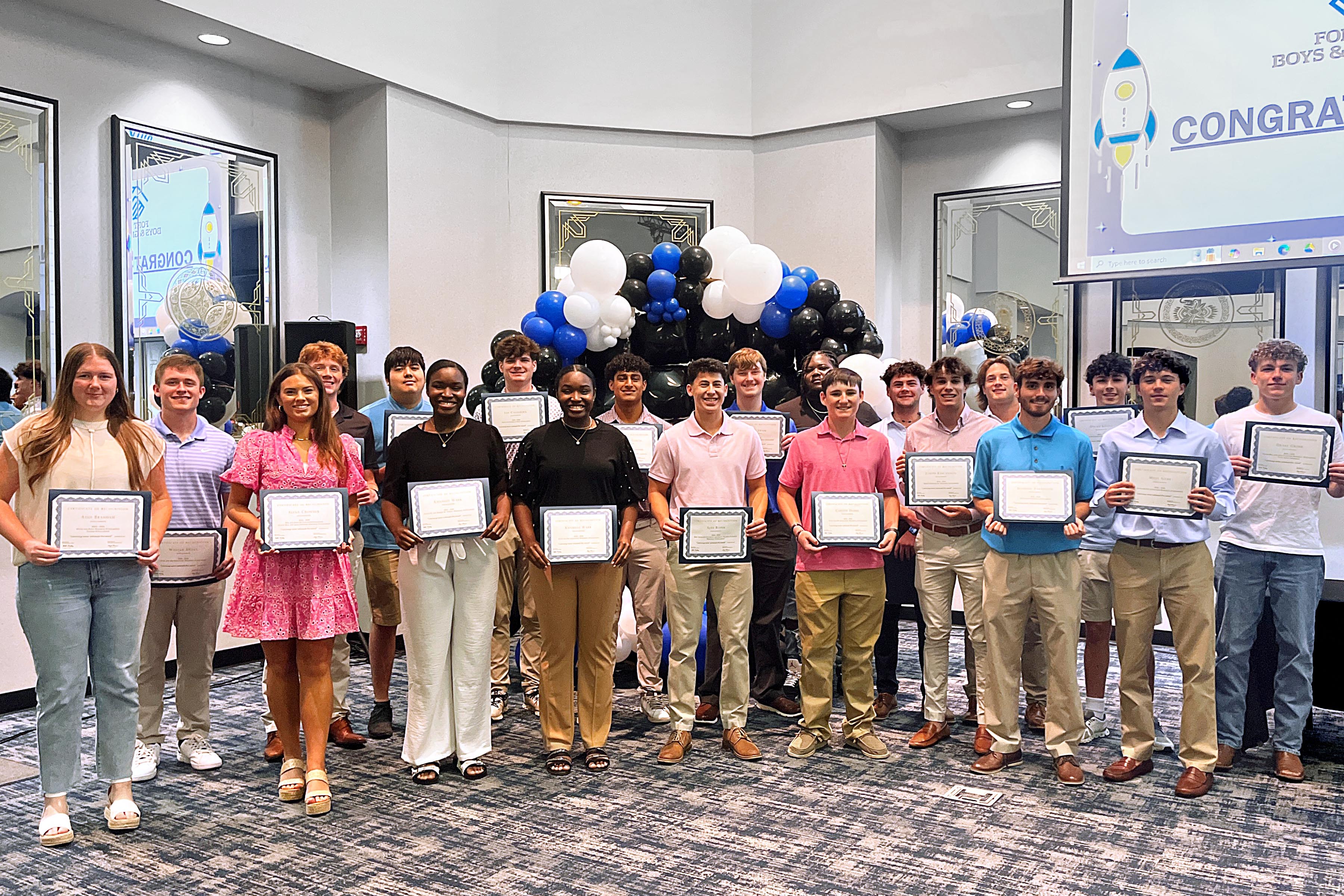 Fort Smith Boys and Girls Club members pose withtheir 2025 scholarships