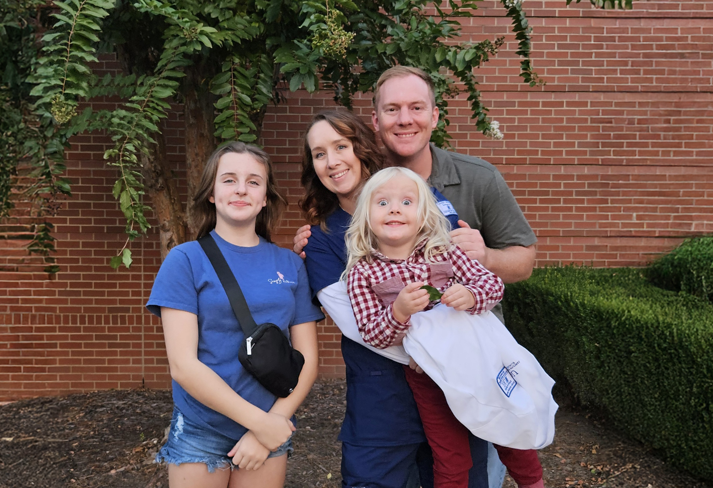 HOlly Needham, UAFS Nursing Student, poses with her family after her White Coat Ceremony