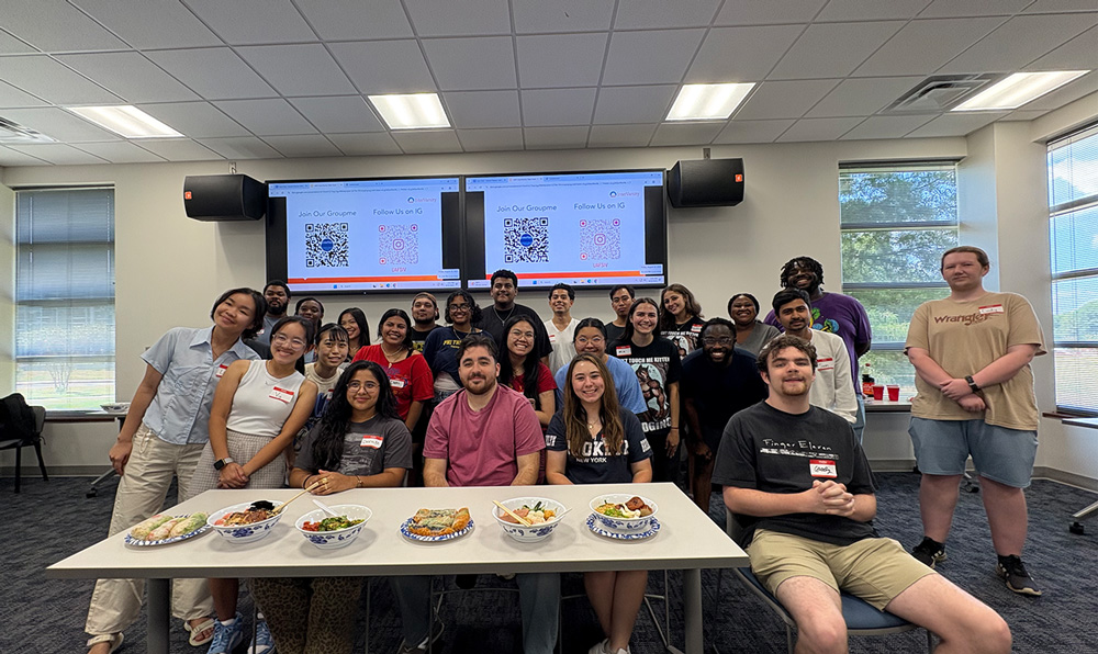 Students gather around the judges at the InterVarsity Christian Fellowship Iron Chef: Instant Ramen Edition competition