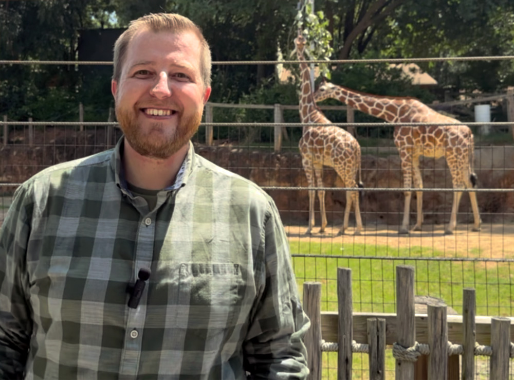 Josiah Olmstead poses with a pair of giraffes at Zoo Atlanta during the filming of his documentary, 