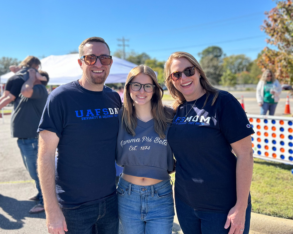 Lucy Clements and her parents smile for a photo together