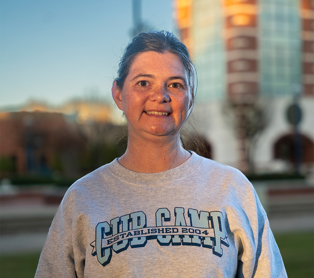 Stephany Dobbins, coordinator for new student and family programs poses in front of the UAFS Bell Tower