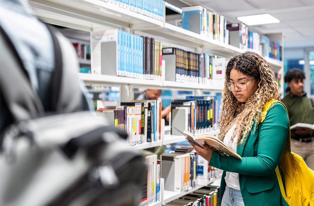Image of college students looking for textbooks at university bookstore